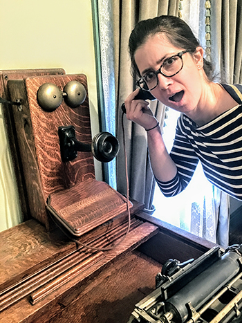 Person pretending to use a historic phone