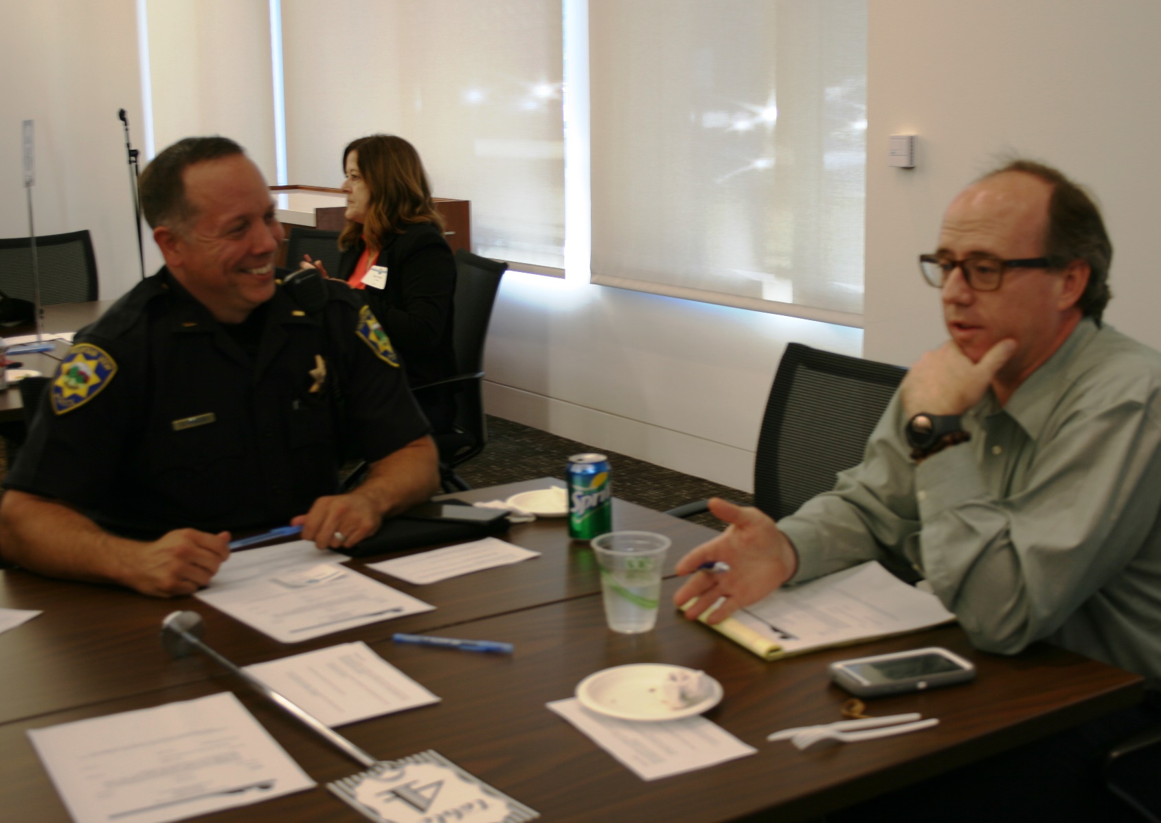 Police officer and City employee at conference table