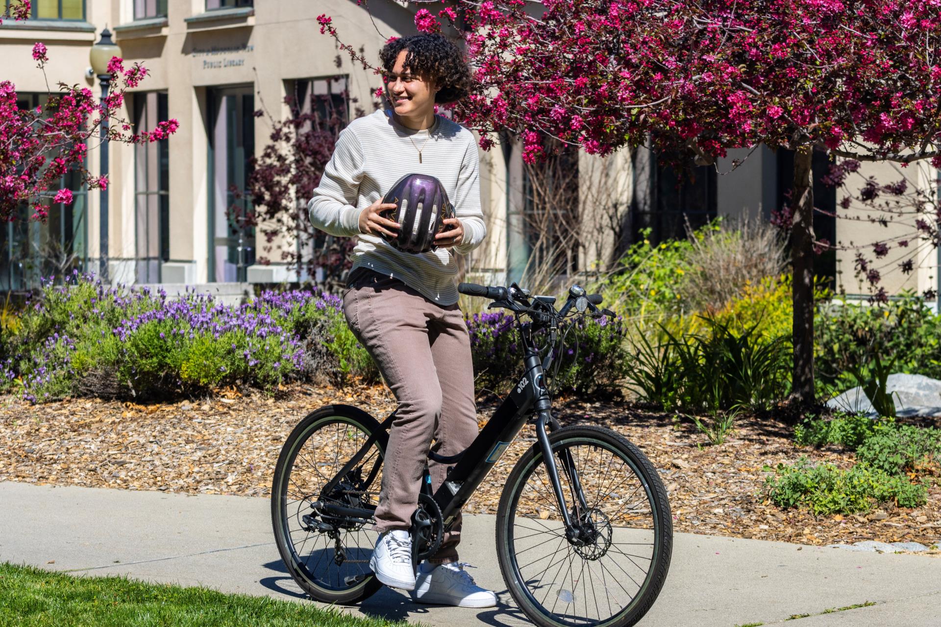 Person Riding E-Bike Near Library - 1 - Landscape - smaller