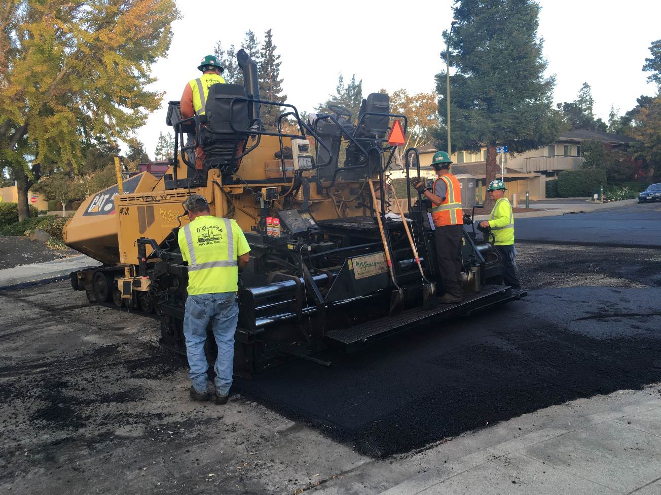 Workers pouring asphalt